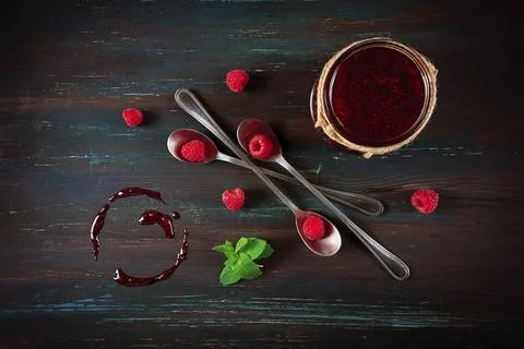 Raspberry jam, on a dark wooden background, top view, selective focus, food Foto stock