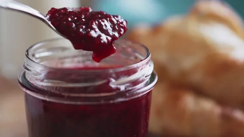 Raspberry jam with fresh baked croissants and milk, close-up. Stock Footage 168682527