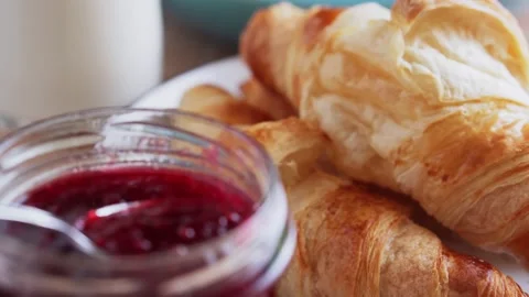 Raspberry jam with fresh baked croissants and milk, close-up. Stock Footage 168682589