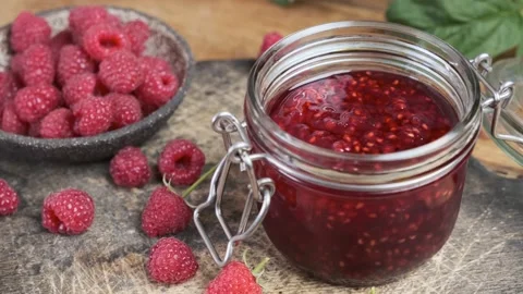 Raspberry jam in a jar with fresh berries. Sweet food. Tasty dessert Stock Footage 218458804