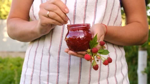 Raspberry jam in a jar in the garden. Selective focus. Stock Footage 275940704