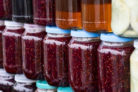 Raspberry jam in jars on the counter. Small home business. Own production. Stock Photos
