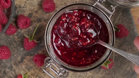 Raspberry jam , marmalade or confiture in a jar. Top view Stock Footage 218461309