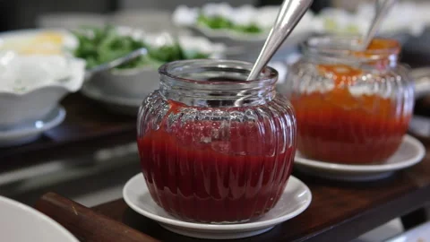 Raspberry jam , marmalade or confiture in a jar with fresh berries. Taking red Stock Footage 310186870