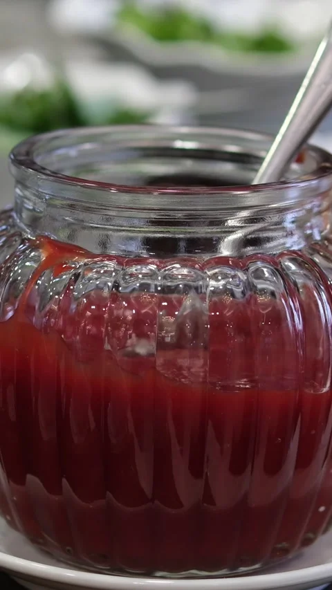 Raspberry jam , marmalade or confiture in a jar with fresh berries. Taking red Stock Footage 310489787