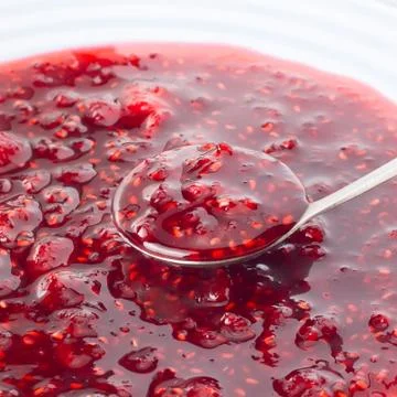 Raspberry jam on the spoon Stock Photos