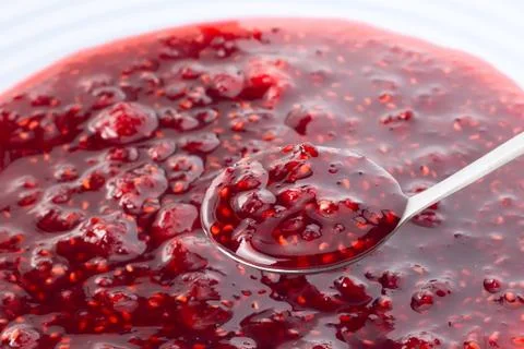 Raspberry jam on the spoon Stock Photos