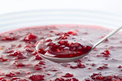 Raspberry jam on the spoon Stock Photos