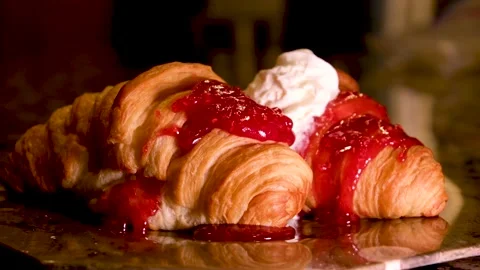 Raspberry jam spreading on bread with a golden spoon, top view. Perfect Video stock 237727117