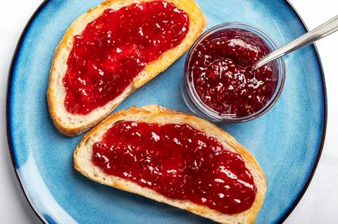 Raspberry jam on toast Stock Photos