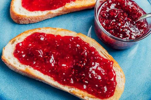 Raspberry jam on toast Stock Photos