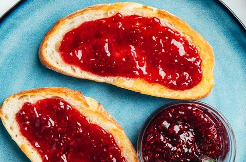 Raspberry jam on toast Stock Photos