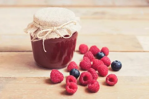 Raspberry jam on a wooden table Stock Photos