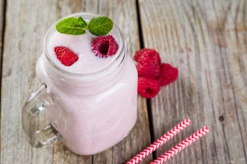 Raspberry jogurt smoothie in glass jar Stock Photos