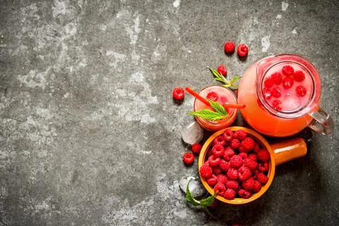 Raspberry juice with the berries and ice. Stock Photos