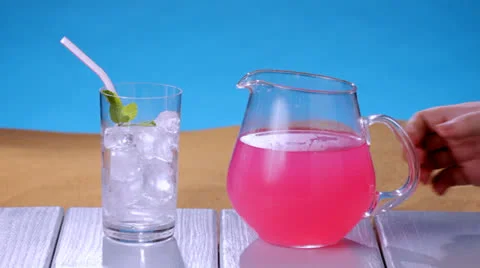 Raspberry lemonade at the beach Stock Footage 23733158