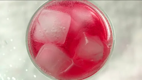 Raspberry lemonade in a glass with ice bubbles Stock Footage 161176859