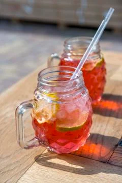 Raspberry lemonade with lemon in wood table Stock Photos