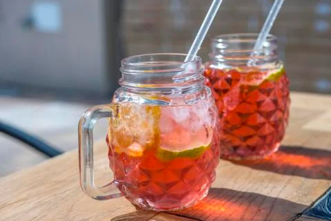 Raspberry lemonade with lemon in wood table Stock Photos