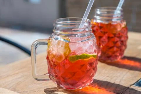Raspberry lemonade with lemon in wood table Stock Photos