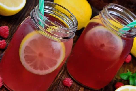 Raspberry lemonade in mason jars on table Foto stock