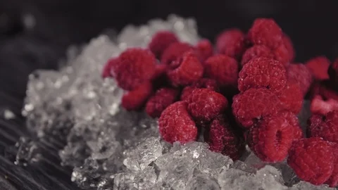 Raspberry lies on ice on a black board Stock Footage 113081973
