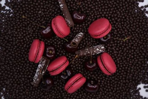Raspberry macaroons on chocolate background  Stock Photos