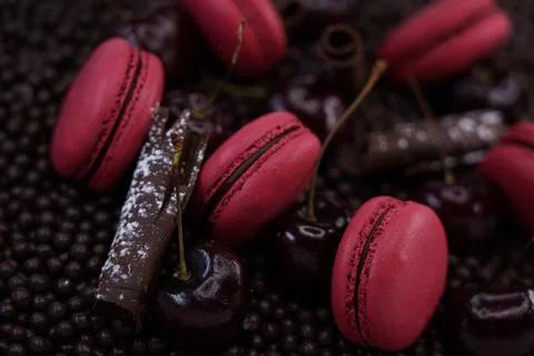 Raspberry macaroons on chocolate background Stock Photos