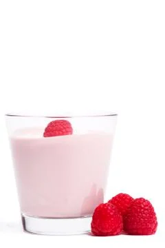 Raspberry on a milkshake with raspberries aside Stock Photos