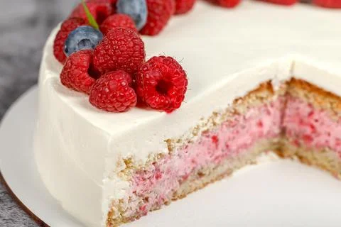 Raspberry mint cake decorated with fresh raspberry and mint leaves 스톡 사진