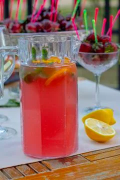 Raspberry mojito drink in jar, cherry blurred background Stock Photos