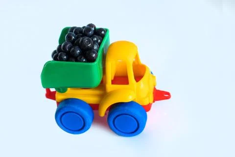 Raspberry natural vitamins are in the back of truck in a children's toy car food Stock Photos