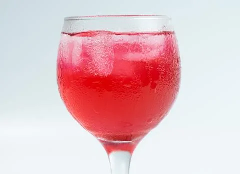Raspberry or frambozen flavored red syrup in glass cup isolated on white ba.. Foto stock