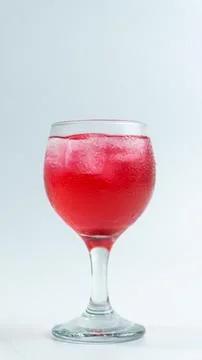 Raspberry or frambozen flavored red syrup in glass cup isolated on white ba.. Stock Photos