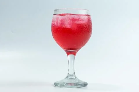 Raspberry or frambozen flavored red syrup in glass cup isolated on white ba.. Stock Photos