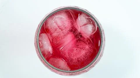 Raspberry or frambozen flavored red syrup in glass cup isolated on white ba.. Stock Photos