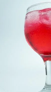 Raspberry or frambozen flavored red syrup in glass cup isolated on white ba.. Stock Photos