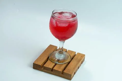 Raspberry or frambozen flavored red syrup in glass cup isolated on white ba.. Stock Photos