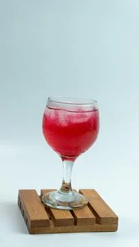 Raspberry or frambozen flavored red syrup in glass cup isolated on white ba.. Stock Photos