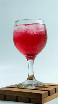 Raspberry or frambozen flavored red syrup in glass cup isolated on white ba.. Foto stock