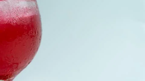 Raspberry or frambozen flavored red syrup in glass cup isolated on white ba.. Stock Photos
