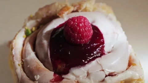 Raspberry pastry dessert glazed pastry close up, cinnamon bun berry fillings. Stock Footage 315510575
