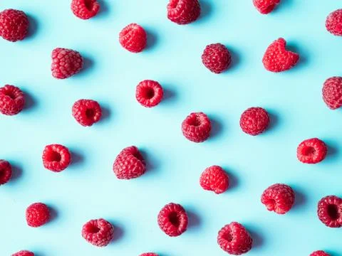 Raspberry pattern, blue background, top view Stock Photos