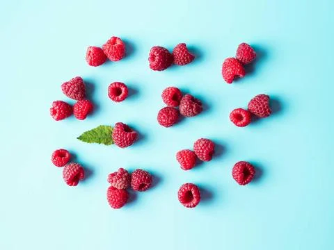 Raspberry pattern, blue background, top view Pattern of ripe red raspberry... Stock Photos