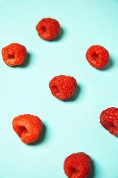 Raspberry pattern on the blue color of the lagoon. Fruits and healthy food,.. Stock Photos