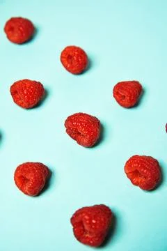 Raspberry pattern on the blue color of the lagoon. Fruits and healthy food,.. Stock Photos