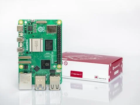 Raspberry Pi 5 single board computer with its official retail box on white Stock-Fotos