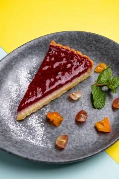 Raspberry pie on a plate on a colored background Stock Photos