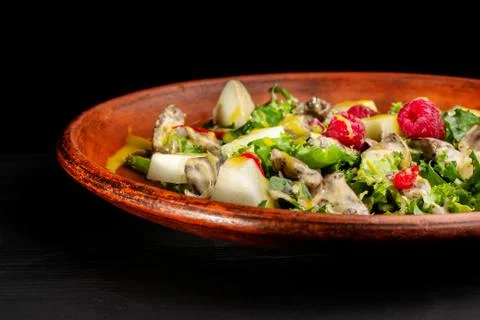 Raspberry, pineapple, lettuce and champignon salad with sauce. Stock Photos