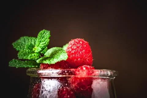 Raspberry. Raspberries in a Cup on a dark background. Summer and healthy food Stock Photos